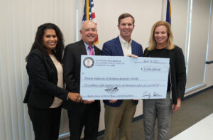 Adams Law partner accepts check from Kentucky governor